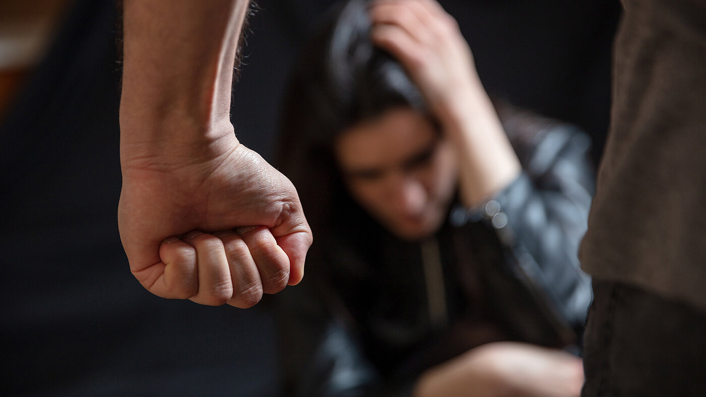 Woman abuse, Young woman scared, male clenched fist close up. Domestic violence